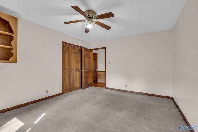 unfurnished bedroom featuring ceiling fan, light carpet, and a closet