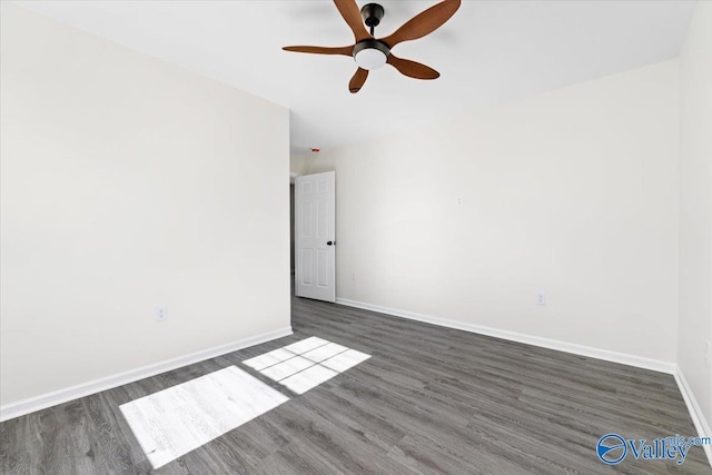 spare room with dark hardwood / wood-style floors and ceiling fan