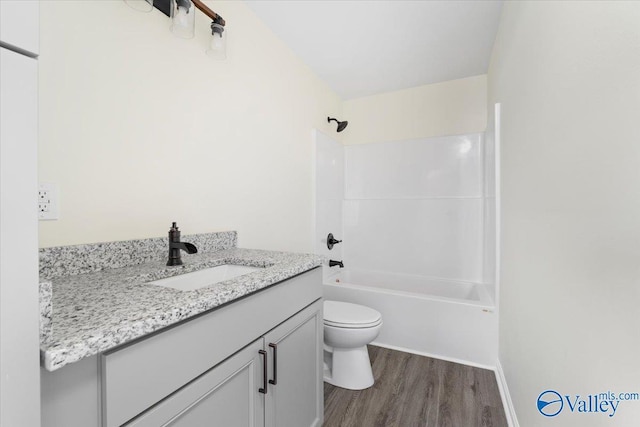 full bathroom with vanity, toilet, hardwood / wood-style floors, and shower / bathing tub combination