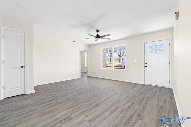 unfurnished living room featuring hardwood / wood-style flooring and ceiling fan