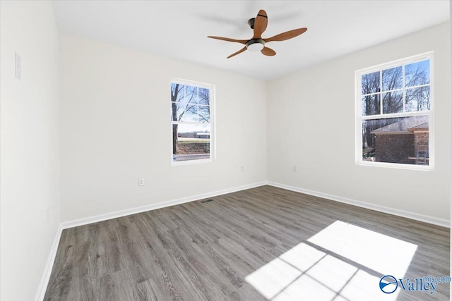 empty room featuring hardwood / wood-style flooring and ceiling fan