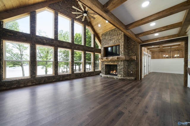 691 County Road 106, Leesburg, AL 35983 - unfurnished living room featuring dark wood finished floors, a stone fireplace, beamed ceiling, a ceiling fan, and high vaulted ceiling