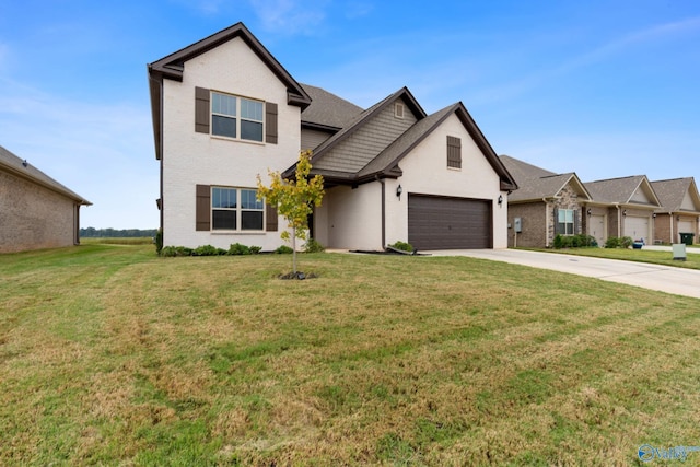 view of front of property featuring a front lawn and a garage