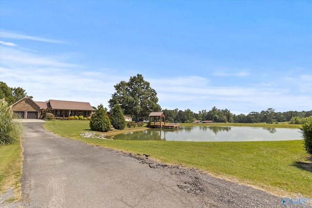 exterior space with a water view and driveway