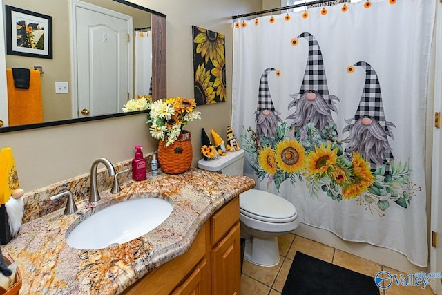 bathroom featuring tile patterned floors, vanity, and toilet