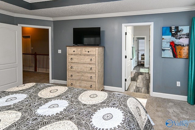 carpeted bedroom with a textured ceiling and crown molding