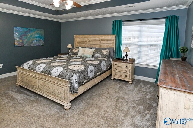 carpeted bedroom featuring ceiling fan, ornamental molding, a textured ceiling, and multiple windows