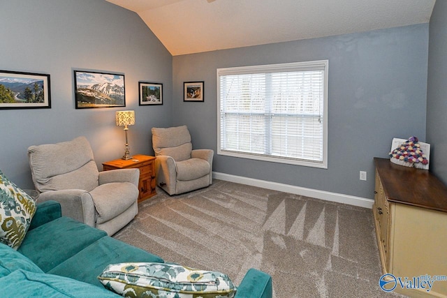 sitting room featuring carpet floors and lofted ceiling