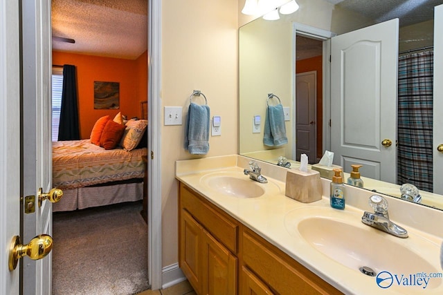 bathroom with vanity and a textured ceiling