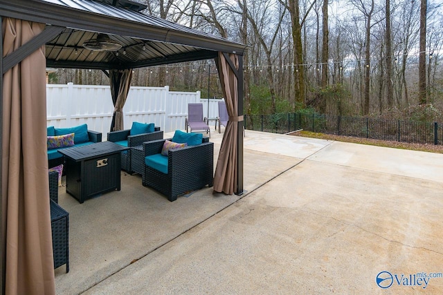 view of patio with a gazebo, an outdoor living space, and ceiling fan