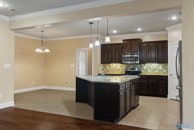 kitchen with a center island, hanging light fixtures, sink, light wood-type flooring, and appliances with stainless steel finishes