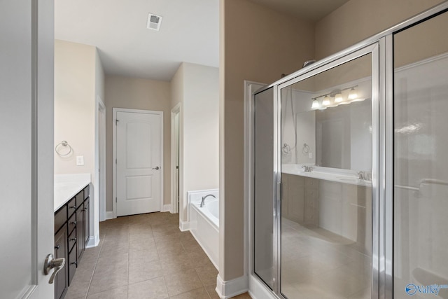 bathroom with vanity, tile patterned floors, and plus walk in shower