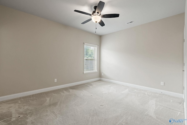 unfurnished room featuring light colored carpet and ceiling fan