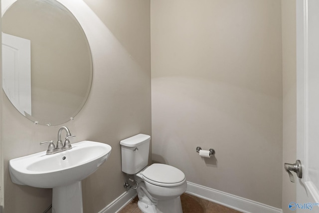 bathroom with tile patterned floors, toilet, and sink