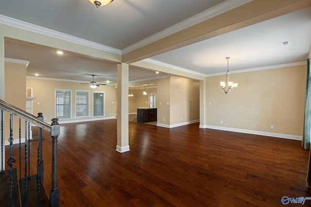 unfurnished living room with dark hardwood / wood-style flooring, ornamental molding, and ceiling fan with notable chandelier