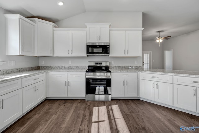 kitchen with white cabinetry, appliances with stainless steel finishes, dark wood-type flooring, and light stone counters