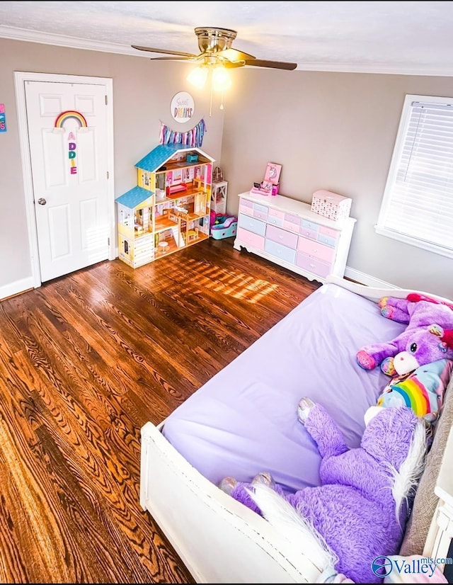 bedroom featuring crown molding, dark hardwood / wood-style floors, and ceiling fan