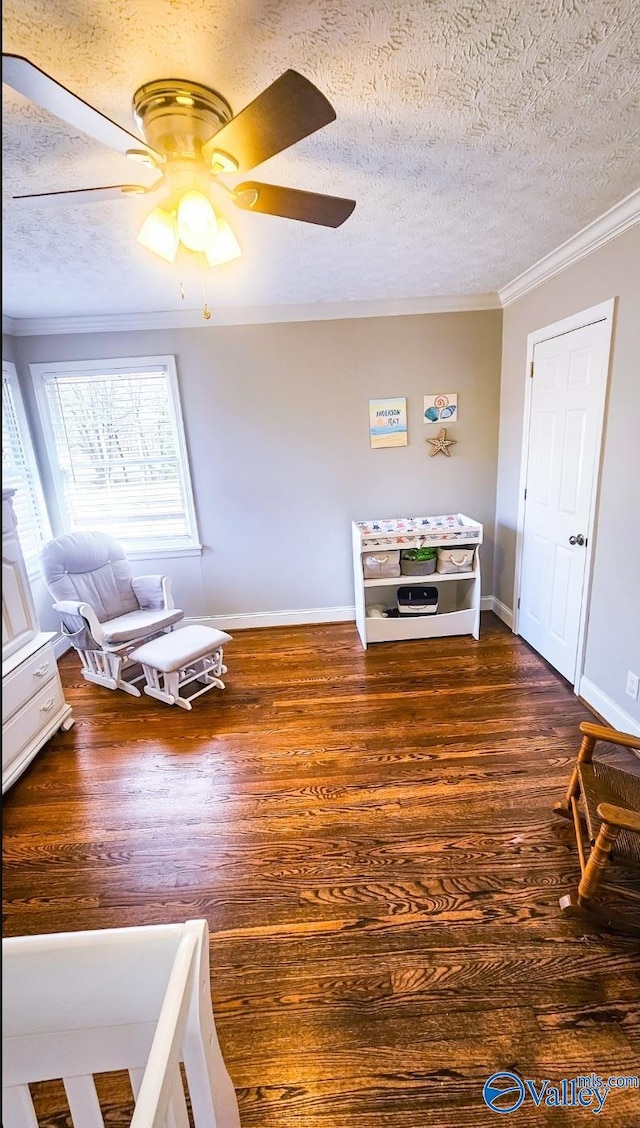 unfurnished room featuring ornamental molding, ceiling fan, a textured ceiling, and dark hardwood / wood-style flooring