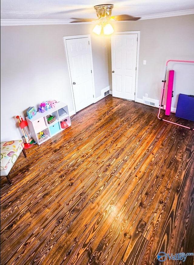 interior space featuring crown molding, dark wood-type flooring, and ceiling fan