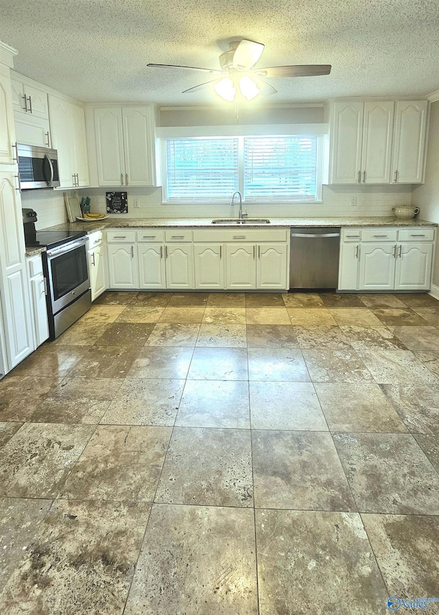 kitchen with white cabinetry, appliances with stainless steel finishes, and sink