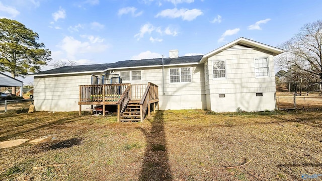 back of house with a wooden deck and a lawn