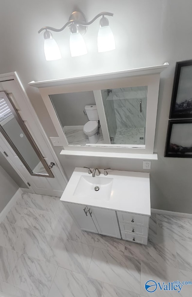 bathroom with a shower, vanity, and toilet