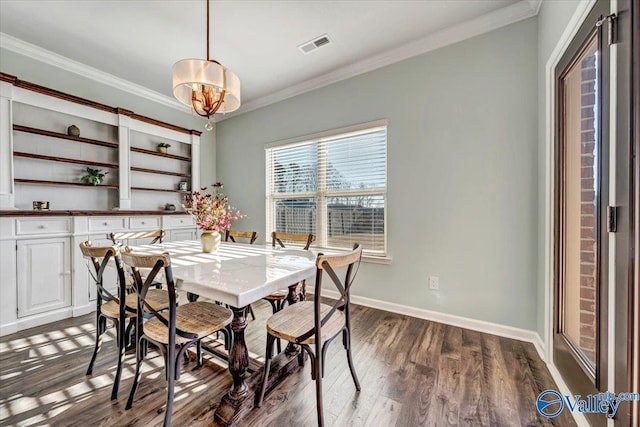 dining room featuring a chandelier, dark hardwood / wood-style flooring, and ornamental molding