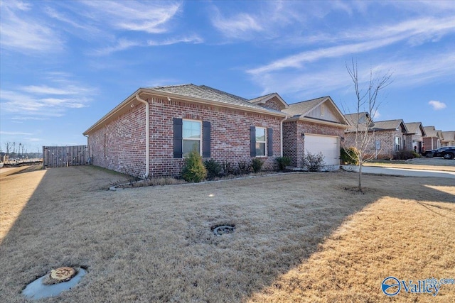 single story home featuring a garage and a front lawn