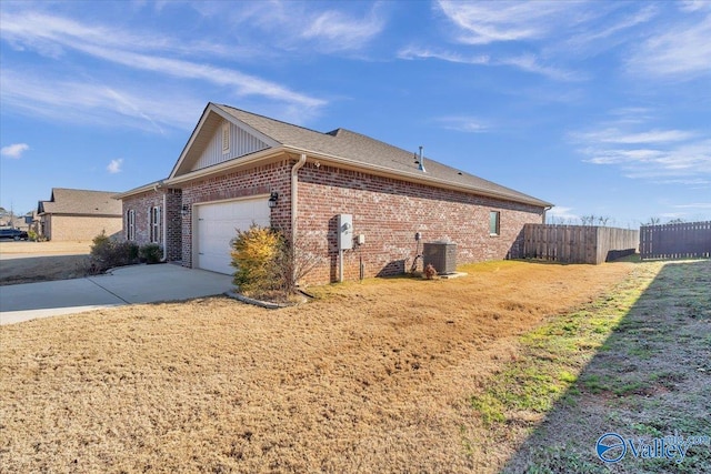 view of side of property featuring a garage and central AC unit