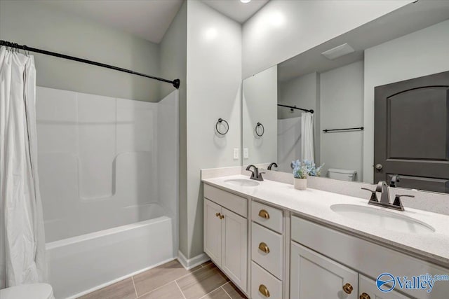 full bathroom featuring shower / tub combo, vanity, and toilet