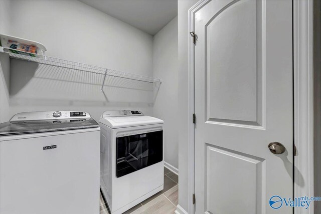 laundry area with washing machine and clothes dryer