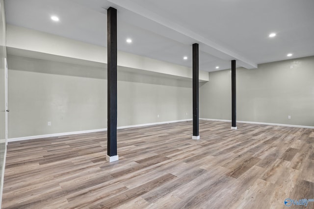 basement with light hardwood / wood-style flooring