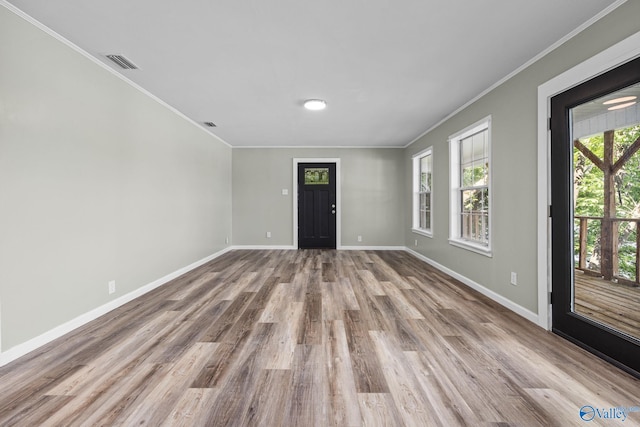 foyer with wood-type flooring and ornamental molding