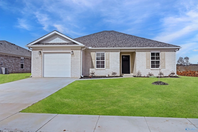 view of front of property with a garage, central AC, and a front yard