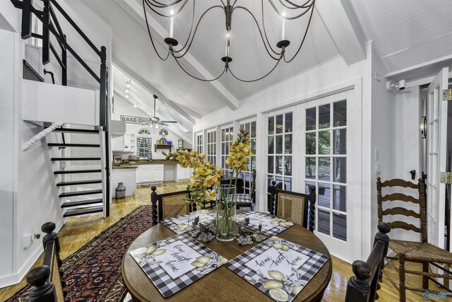 dining room with high vaulted ceiling, beamed ceiling, french doors, and light hardwood / wood-style flooring