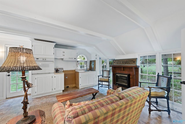 tiled living room with vaulted ceiling and a wealth of natural light