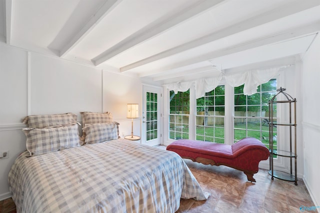 bedroom with beamed ceiling, light tile patterned flooring, and access to outside