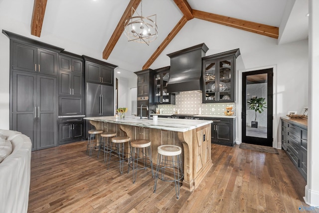 27 Watson Grande Way, Owens Cross Roads, AL 35763 - kitchen featuring beamed ceiling, backsplash, glass insert cabinets, high end refrigerator, and a chandelier