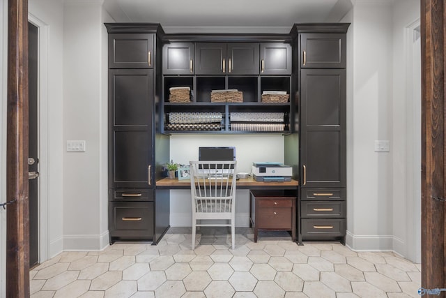 27 Watson Grande Way, Owens Cross Roads, AL 35763 - home office featuring built in study area, baseboards, light tile patterned floors, and ornamental molding