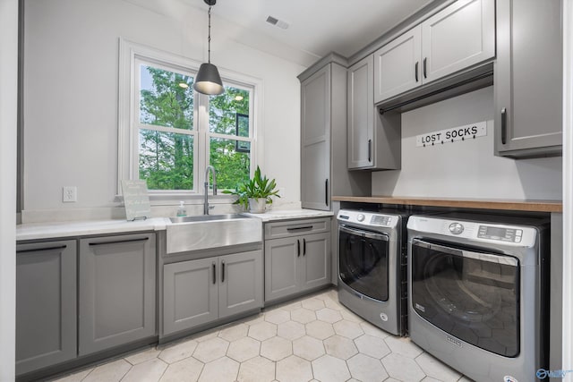 27 Watson Grande Way, Owens Cross Roads, AL 35763 - laundry area with cabinet space, independent washer and dryer, and light tile patterned flooring