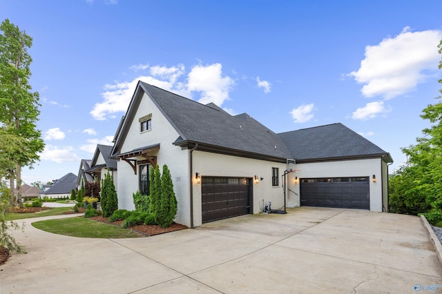 27 Watson Grande Way, Owens Cross Roads, AL 35763 - view of side of property featuring a garage, concrete driveway, and roof with shingles