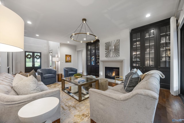 27 Watson Grande Way, Owens Cross Roads, AL 35763 - living room featuring a glass covered fireplace, recessed lighting, wood-type flooring, and a chandelier