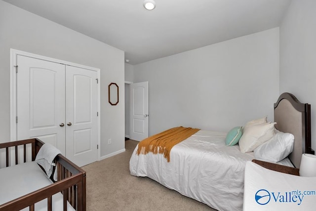 carpeted bedroom with a closet