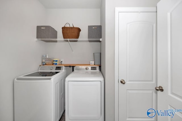 clothes washing area with washer and clothes dryer