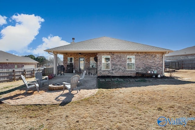 back of property with a patio and a fire pit