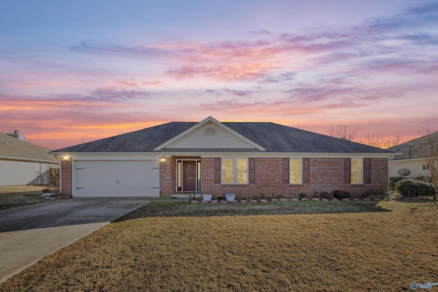 single story home with a garage and a lawn