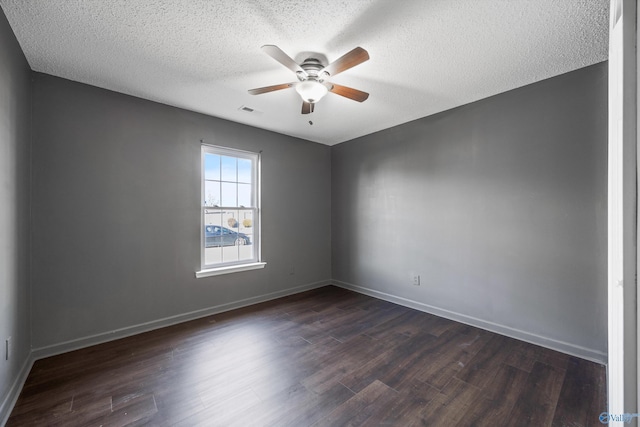 spare room featuring ceiling fan, dark hardwood / wood-style flooring, and a textured ceiling