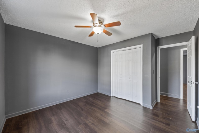 unfurnished bedroom with a closet, dark hardwood / wood-style floors, a textured ceiling, and ceiling fan