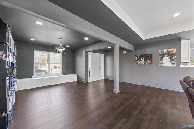 unfurnished living room featuring dark wood-type flooring