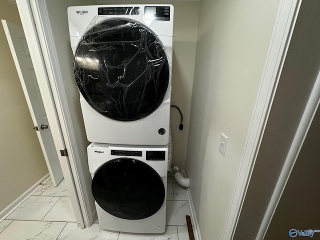 laundry room featuring stacked washer / drying machine